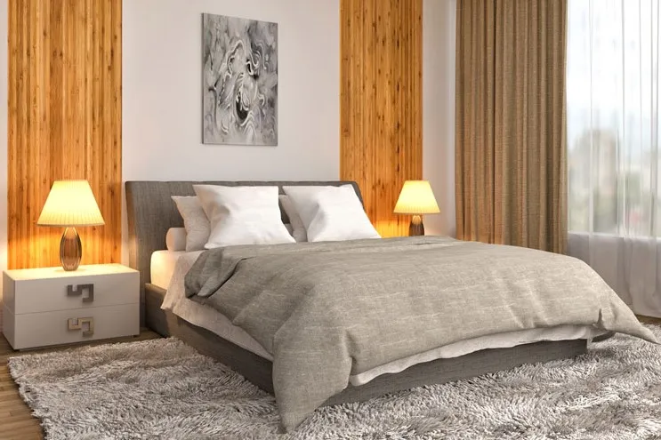 A calm bedroom with a soft, deep-pile rug at the foot of the bed